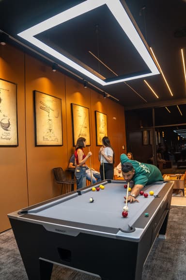 Friends playing pool at the first table by the entrance