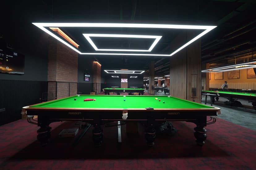 Snooker table under hexagonal lights at THE BLACK SPOT, Marrakech